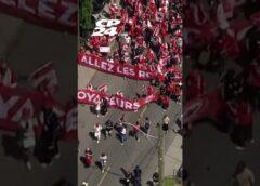 Fans decked out in red march through the streets of Toronto ahead of World Cup match
